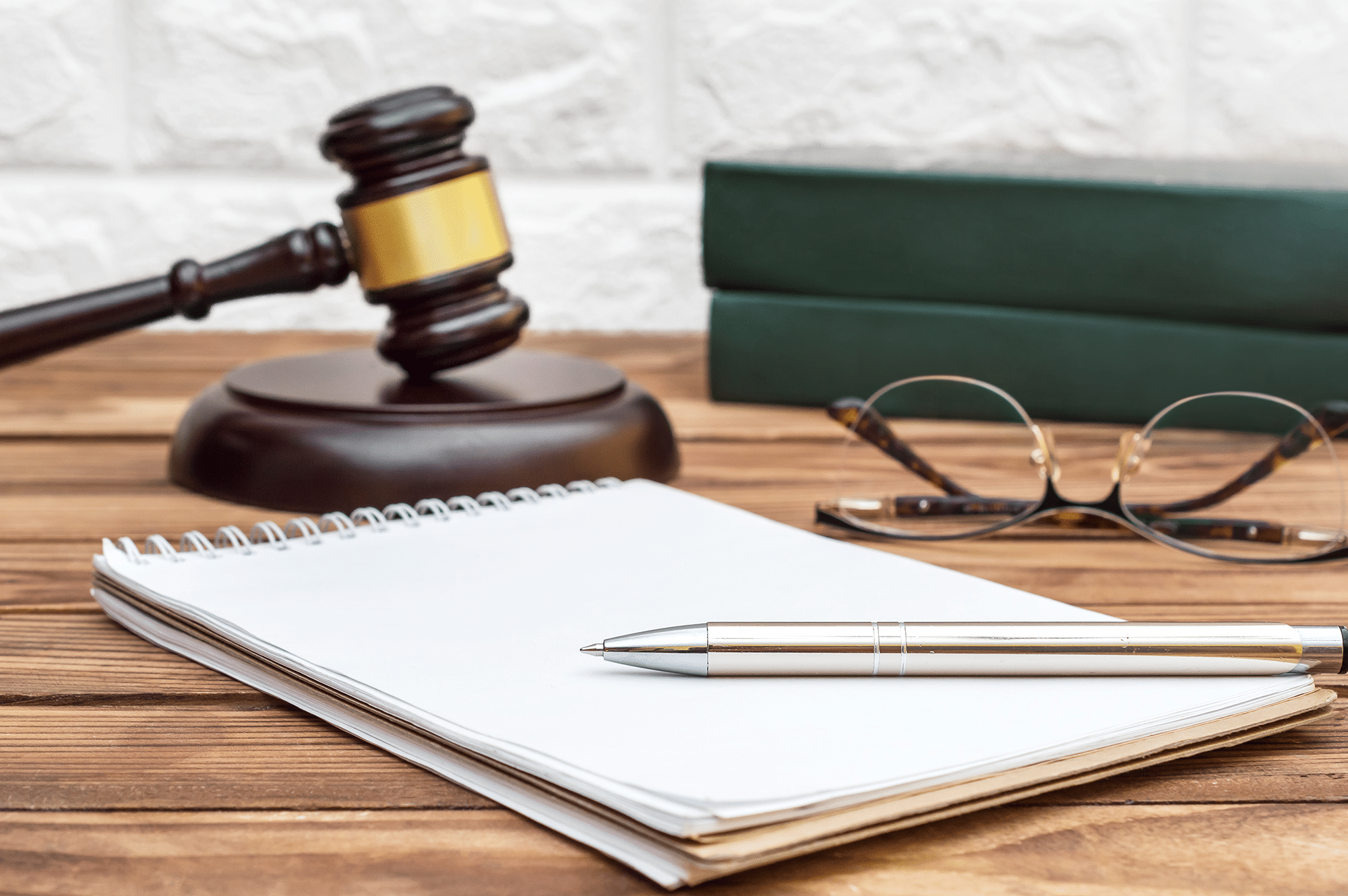 A stack of bankruptcy record documents on a desk with a gavel placed on top.